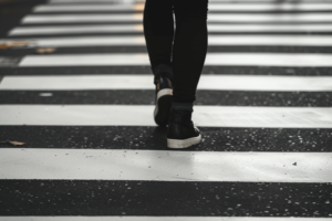 a person walking over a pedestrian crossing